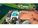 Aerial view of the community pool, clubhouse, and golf course surrounded by trees at 4228 Presidential Avenue E Cir, Bradenton, FL 34203