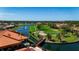 Expansive aerial view of a golf course community featuring waterways, lush greenery, and residential homes at 4228 Presidential Avenue E Cir, Bradenton, FL 34203