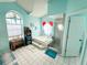 Large bathroom with tiled floor, large tub, walk-in shower, and decorative window at 4228 Presidential Avenue E Cir, Bradenton, FL 34203