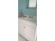 Bathroom vanity with white cabinet and white countertop with a decorative mirror above it at 4228 Presidential Avenue E Cir, Bradenton, FL 34203