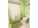 Bathroom featuring a tropical-themed shower curtain, toilet, and tile flooring for easy maintenance at 4228 Presidential Avenue E Cir, Bradenton, FL 34203