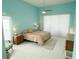 Bedroom with tile flooring, ceiling fan, two side tables, and large windows with blinds at 4228 Presidential Avenue E Cir, Bradenton, FL 34203