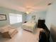 Cozy bedroom featuring tile flooring, a ceiling fan, and ample natural light from the window at 4228 Presidential Avenue E Cir, Bradenton, FL 34203