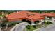 Aerial view of the community clubhouse and fountain surrounded by lush landscaping at 4228 Presidential Avenue E Cir, Bradenton, FL 34203