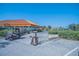 Image of the community clubhouse featuring golf carts and a bag drop off area on a sunny day at 4228 Presidential Avenue E Cir, Bradenton, FL 34203