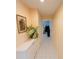 Hallway with tiled flooring showcasing a decorative plant and wall art, creating a welcoming atmosphere at 4228 Presidential Avenue E Cir, Bradenton, FL 34203