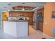 Modern kitchen featuring stainless steel appliances, a breakfast bar, and wood cabinetry at 4228 Presidential Avenue E Cir, Bradenton, FL 34203