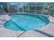 Beautiful pool with clear, refreshing water, integrated waterfall feature, and a paved surround at 4228 Presidential Avenue E Cir, Bradenton, FL 34203