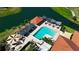 Aerial view of a sparkling pool with cabanas and lounge areas near a scenic lake and lush landscaping at 4228 Presidential Avenue E Cir, Bradenton, FL 34203