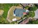 Aerial view of the home, its roof, and the surrounding landscaping and fenced yard at 426 Village Dr, Tarpon Springs, FL 34689