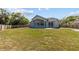 Large backyard with a sprawling lawn and mature trees, offering ample space for outdoor activities at 426 Village Dr, Tarpon Springs, FL 34689