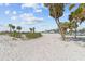 Beautiful white sand beach with palm trees and blue skies, perfect for a relaxing day at 426 Village Dr, Tarpon Springs, FL 34689