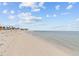 Calm ocean view with a sandy beach, scattered shorebirds, and clear skies for peaceful strolls at 426 Village Dr, Tarpon Springs, FL 34689