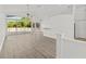 Bright living room with vaulted ceilings and large windows overlooking the backyard at 426 Village Dr, Tarpon Springs, FL 34689