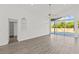Empty living room with vaulted ceilings, recessed lighting, and sliding glass doors to the backyard at 426 Village Dr, Tarpon Springs, FL 34689