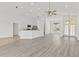 Open living area with kitchen view, vaulted ceiling, recessed lighting, and bright windows at 426 Village Dr, Tarpon Springs, FL 34689
