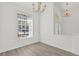 Bright and airy living room with a modern chandelier and view to the exterior at 426 Village Dr, Tarpon Springs, FL 34689