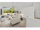 Bright living room with vaulted ceilings, neutral tones, and large windows overlooking the backyard at 426 Village Dr, Tarpon Springs, FL 34689