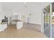 Open living area connecting to kitchen and lanai, featuring lots of natural light and neutral tones at 426 Village Dr, Tarpon Springs, FL 34689