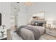 Stylishly staged main bedroom with en suite bath and a serene color palette at 426 Village Dr, Tarpon Springs, FL 34689