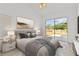 Stylishly staged main bedroom with a sliding glass door that opens to the backyard at 426 Village Dr, Tarpon Springs, FL 34689