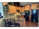 Traditional kitchen featuring wooden cabinets, dark countertops, and modern appliances at 4315 Longshore Dr, Land O Lakes, FL 34639