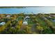 Gorgeous aerial view shows the waterfront property, manicured grounds, and mature trees at 450 Bayshore Dr, Terra Ceia, FL 34250