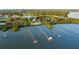 Aerial view of waterfront property with long docks extending into the bay at 450 Bayshore Dr, Terra Ceia, FL 34250