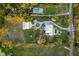 Breathtaking aerial view showcasing an estate with manicured lawns and lush landscaping at 450 Bayshore Dr, Terra Ceia, FL 34250