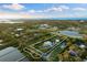 Aerial view highlights a waterfront estate amid lush greenery and expansive waterways at 450 Bayshore Dr, Terra Ceia, FL 34250