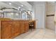Bathroom featuring wood cabinets, a large mirror, a separate shower area, and vanity at 450 Bayshore Dr, Terra Ceia, FL 34250