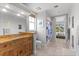 Bathroom with a rustic vanity, granite countertop, and a view of the bedroom at 450 Bayshore Dr, Terra Ceia, FL 34250