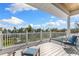 Spacious deck with seating overlooking lush greenery and a distant waterfront view at 450 Bayshore Dr, Terra Ceia, FL 34250