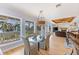 Bright dining room featuring a glass table, stylish chairs, and scenic outdoor views through large windows at 450 Bayshore Dr, Terra Ceia, FL 34250