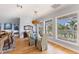 Elegant dining room with stylish chandelier, large windows, and hardwood floors at 450 Bayshore Dr, Terra Ceia, FL 34250