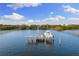 Aerial view of a private dock with a boat lift on the water at 450 Bayshore Dr, Terra Ceia, FL 34250