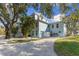 Beautiful light blue two-story home with well-manicured landscaping including a white rock driveway at 450 Bayshore Dr, Terra Ceia, FL 34250