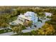 Expansive estate featuring a luxurious pool, tiki bar, circular driveway, and pristine landscaping at 450 Bayshore Dr, Terra Ceia, FL 34250