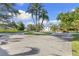 Circular driveway with lush grass island and many palm trees in front of the oversized garage at 450 Bayshore Dr, Terra Ceia, FL 34250