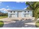 Spacious detached garage with three bays and large parking area, and an upstairs level at 450 Bayshore Dr, Terra Ceia, FL 34250