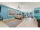 Brightly colored gym with exercise equipment, a cozy sofa, and ample space at 450 Bayshore Dr, Terra Ceia, FL 34250