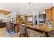 Open concept kitchen boasts custom wood cabinets, granite countertops, pendant lighting and seamless flow to living spaces at 450 Bayshore Dr, Terra Ceia, FL 34250