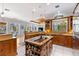 Gourmet kitchen with custom wood cabinetry, granite countertops, prep island, and open layout to dining area at 450 Bayshore Dr, Terra Ceia, FL 34250