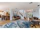 Bright living room featuring hardwood floors, staircase, and stylish coastal decor at 450 Bayshore Dr, Terra Ceia, FL 34250