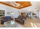 Spacious living room featuring hardwood floors, neutral paint, wood ceiling, and seamless transition to kitchen at 450 Bayshore Dr, Terra Ceia, FL 34250