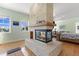Living room featuring a stone fireplace, bright windows, and an attached bedroom at 450 Bayshore Dr, Terra Ceia, FL 34250