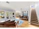Open concept living room with hardwood floors, a staircase, and access to a porch at 450 Bayshore Dr, Terra Ceia, FL 34250