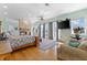 Spacious main bedroom with hardwood floors, access to a balcony, and a fireplace at 450 Bayshore Dr, Terra Ceia, FL 34250