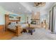 Large main bedroom featuring a stone fireplace, hardwood floors, and a sitting area at 450 Bayshore Dr, Terra Ceia, FL 34250