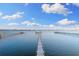 Picturesque view down a long pier into the calm bay waters under a sunny sky at 450 Bayshore Dr, Terra Ceia, FL 34250